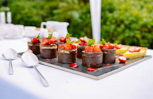 Picture of mini desserts on a white table cloth settings served at a catering in Miami Lakes